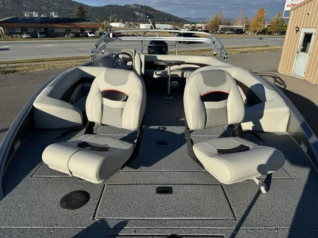 Slide: The Image of 2023 Lowe SD224 boat interior with two seats, gray flooring, and steering console. - 6