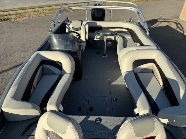 Slide: The Image of 2023 Lowe SD224 boat interior with plush seating and steering console. - 9