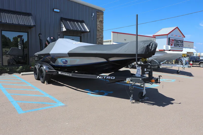 Slide: The Image of 2023 Nitro Z20 Pro boat covered on trailer in parking lot. - 10