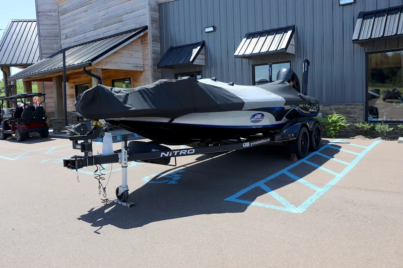 Slide: The Image of 2023 Nitro Z20 Pro boat on trailer, covered, parked outside building. - 11