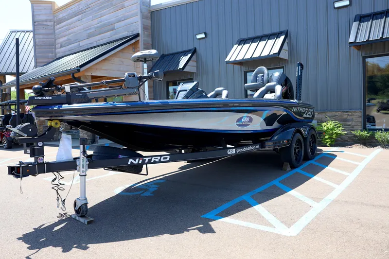 Slide: The Image of 2023 Nitro Z20 Pro fishing boat on trailer, parked outside a building. - 2