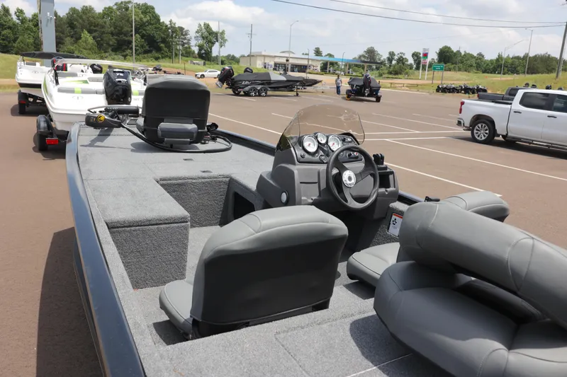 Slide: The Image of 2023 Tracker Pro 170 boat in parking lot, featuring steering console and seating. - 3
