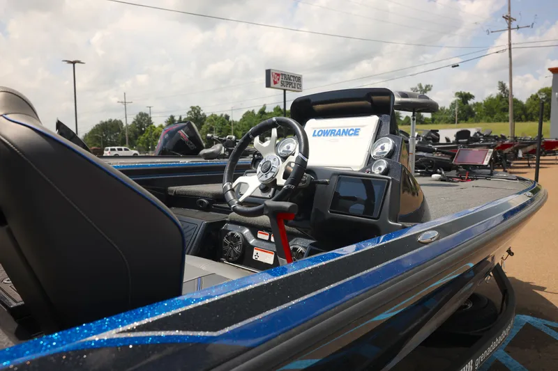 Slide: The Image of 2024 Nitro Z21 XL Pro boat interior with steering wheel and Lowrance electronics. - 2