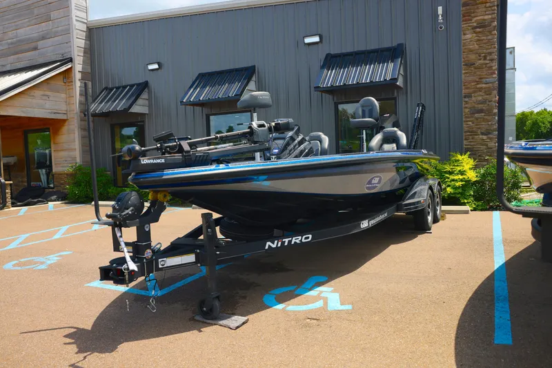 Slide: The Image of 2024 Nitro Z21 XL Pro boat parked outside a building on a sunny day. - 4