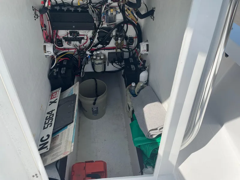 Slide: The Image of 2023 Rambo 27 boat with Minn Kota Terrova motor, surrounded by winter trees. - 10