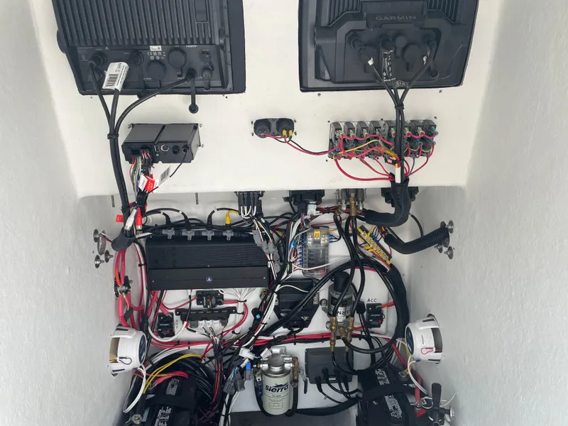 Slide: The Image of 2023 Rambo 27 boat docked in a parking lot with trees in the background. - 11