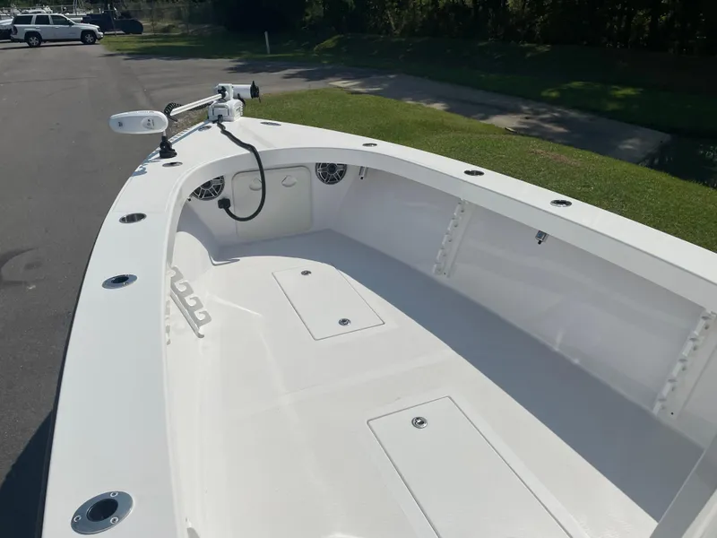 Slide: The Image of 2023 Rambo 27 boat interior with storage compartments and rod holders. - 12