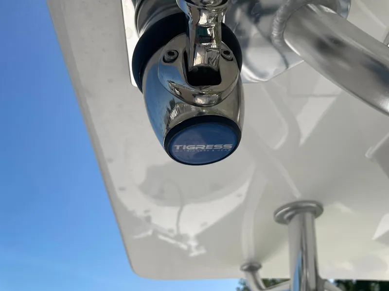 Slide: The Image of Boat console with dual Garmin screens, steering wheel, and controls on a 2023 Rambo 27. - 17