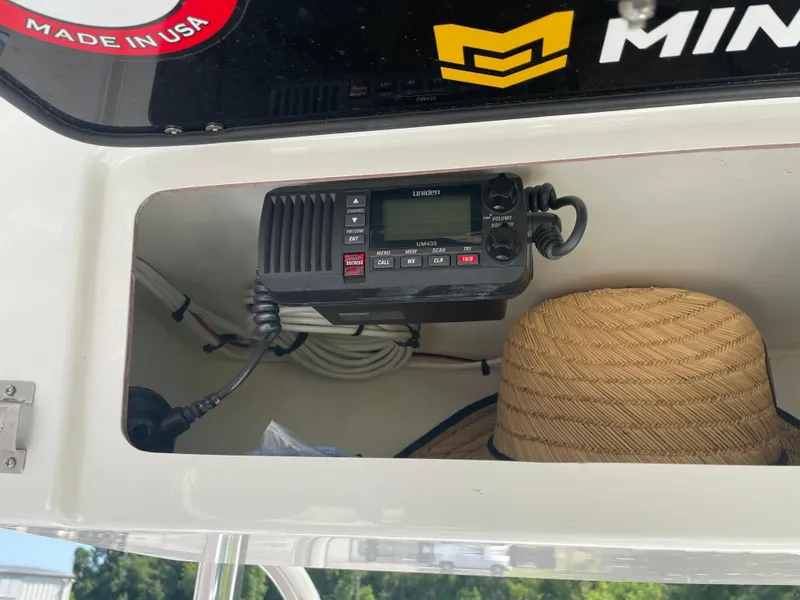 Slide: The Image of 2023 Rambo 27 boat on trailer, parked outdoors near industrial building. - 7