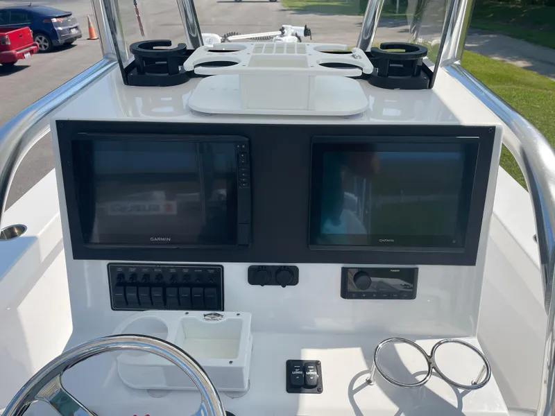 Slide: The Image of 2023 Rambo 27 boat on trailer in parking lot with surrounding vehicles. - 8