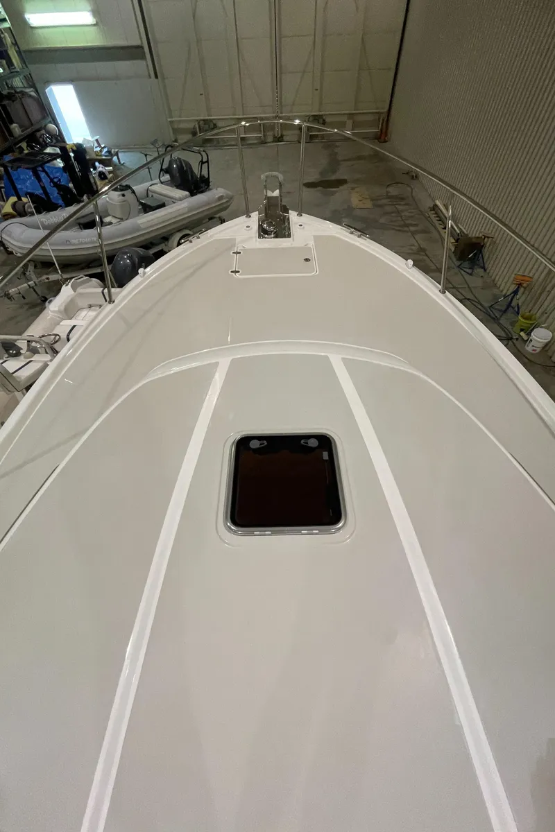 Slide: The Image of 2025 Back Cove 372 boat deck in a storage facility, showcasing sleek design and craftsmanship. - 13