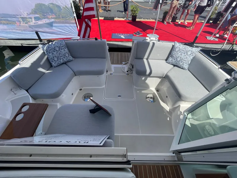 Slide: The Image of 2025 Back Cove 372 boat interior with gray seating and decorative cushions. - 18
