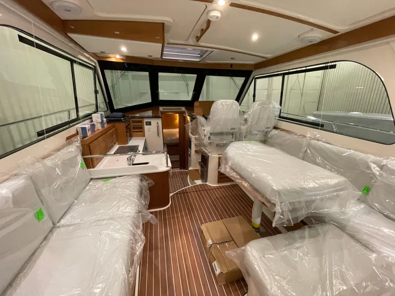 Slide: The Image of Interior of 2025 Back Cove 372 yacht with modern seating and wooden flooring. - 20