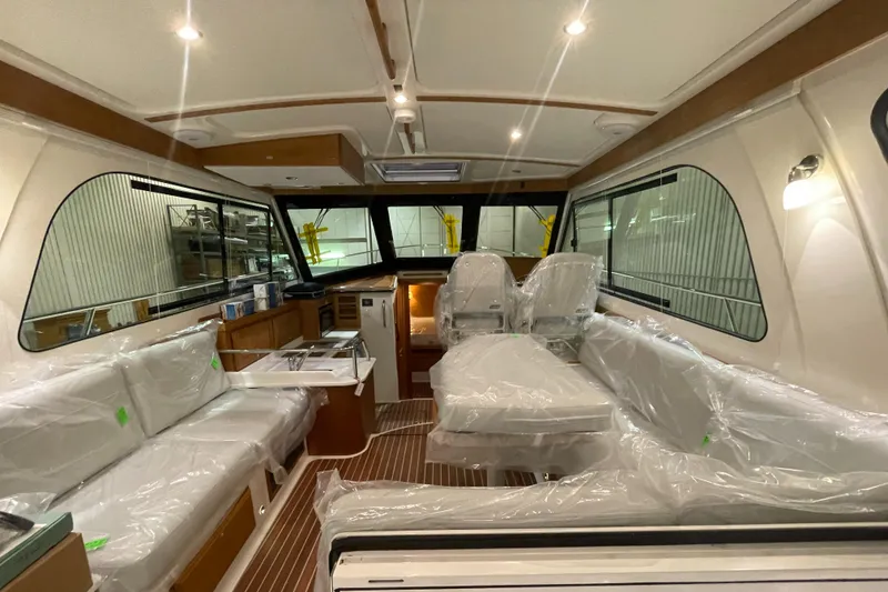 Slide: The Image of 2025 Back Cove 372 yacht interior with modern seating and elegant design. - 21