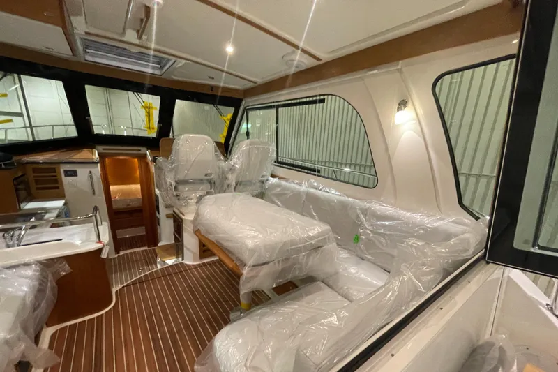 Slide: The Image of 2025 Back Cove 372 yacht interior with plush seating and modern design. - 22