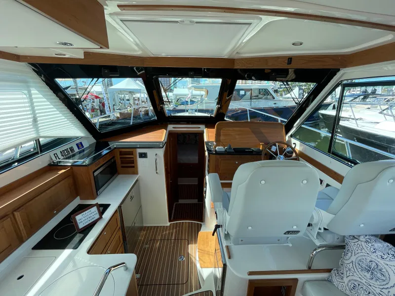 Slide: The Image of Interior of 2025 Back Cove 372 yacht, featuring modern helm and luxurious seating. - 24