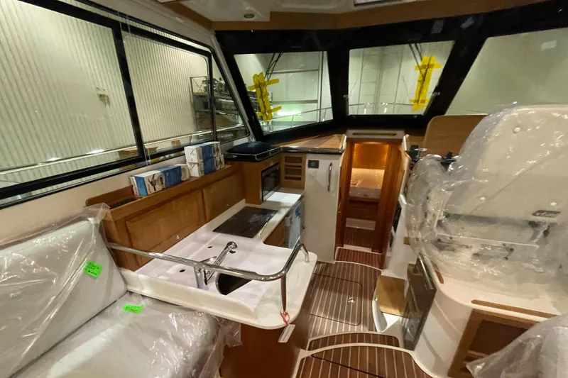 Slide: The Image of Interior of 2025 Back Cove 372 yacht, featuring modern kitchen and seating area. - 29