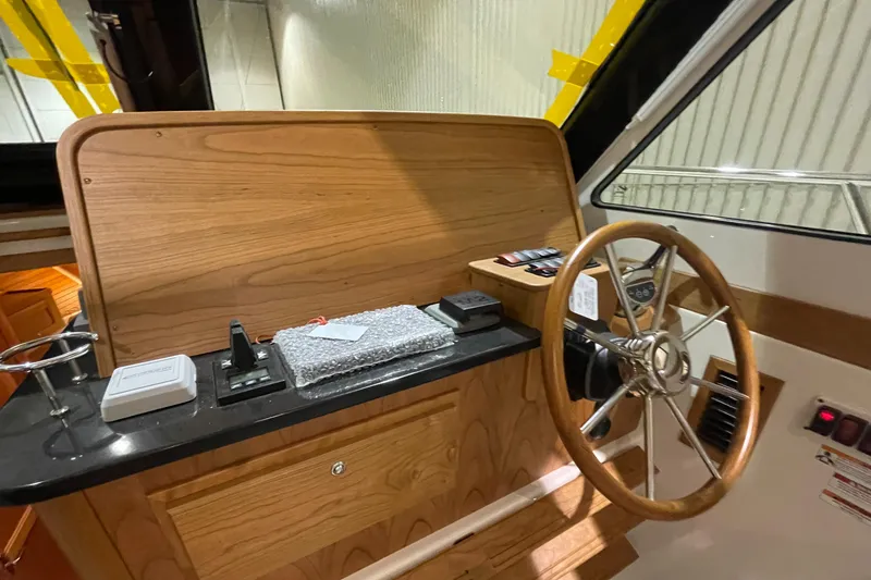 Slide: The Image of 2025 Back Cove 372 helm with wooden dashboard and steering wheel. - 33