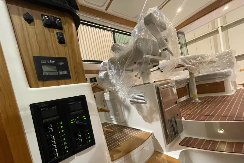 Slide: The Image of 2025 Back Cove 372 yacht interior with wood accents and wrapped seating. - 34