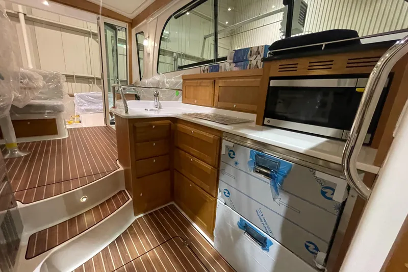Slide: The Image of 2025 Back Cove 372 yacht interior with modern kitchen and wood flooring. - 39