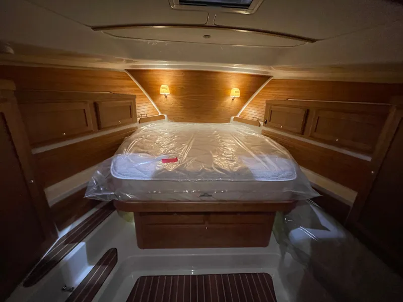 Slide: The Image of 2025 Back Cove 372 cabin interior with cozy lighting and wooden accents. - 41