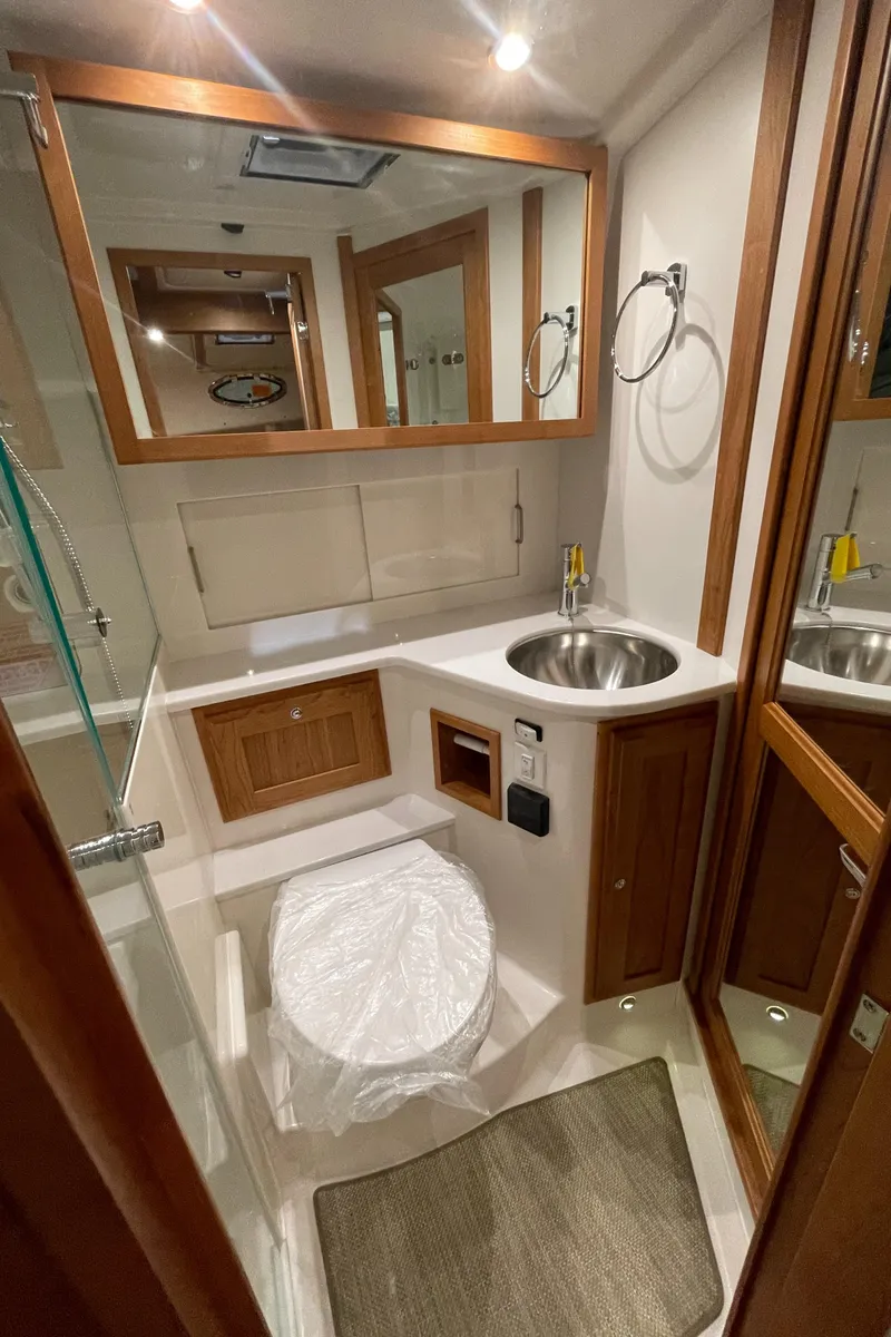 Slide: The Image of Luxurious bathroom in 2025 Back Cove 372 yacht with modern fixtures and wooden accents. - 45
