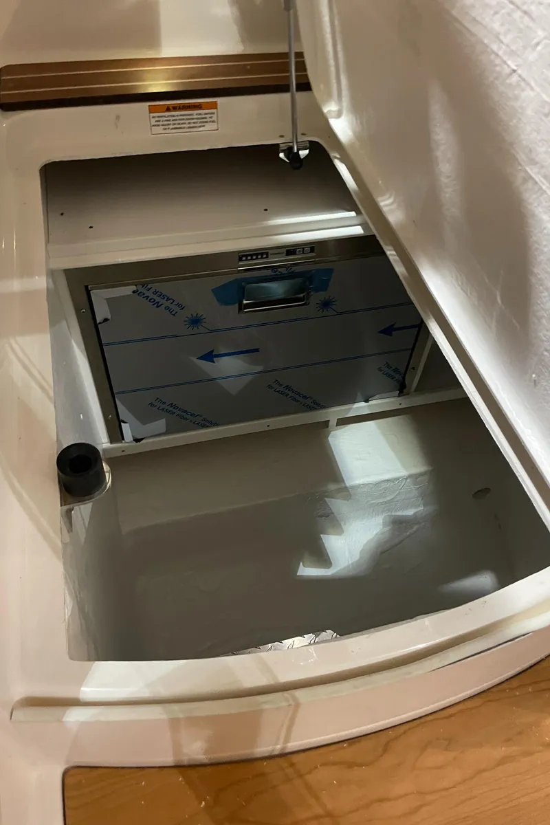 Slide: The Image of 2025 Back Cove 372 interior compartment with reflective surface and visible hardware. - 49