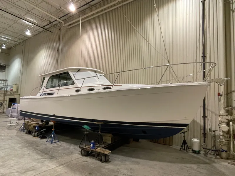 Slide: The Image of 2025 Back Cove 372 yacht in a warehouse, showcasing sleek design and modern features. - 6