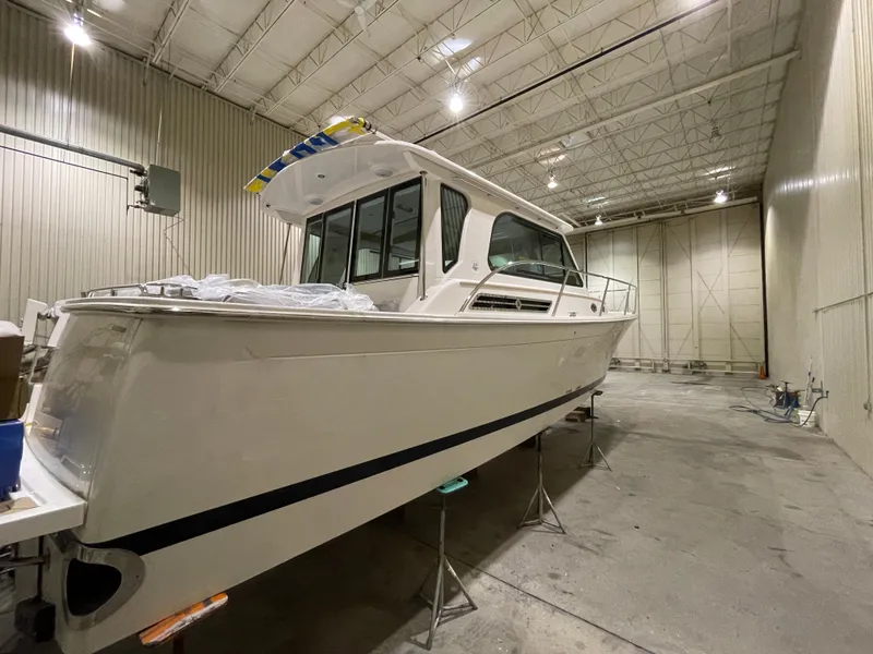 Slide: The Image of 2025 Back Cove 372 boat in a spacious indoor storage facility. - 9