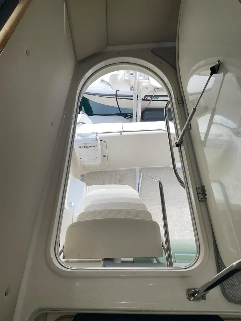 Slide: The Image of Interior view of 1997 Maxum 4600 Custom SCB yacht, showcasing seating and hatch. - 13