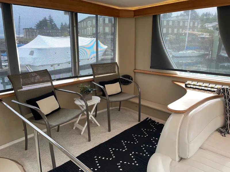 Slide: The Image of Interior of 1997 Maxum 4600 Custom SCB yacht with chairs and scenic marina view. - 15