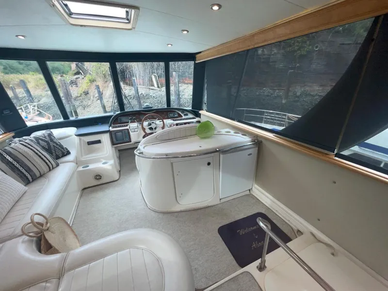 Slide: The Image of Interior of 1997 Maxum 4600 Custom SCB yacht with plush seating and helm. - 18