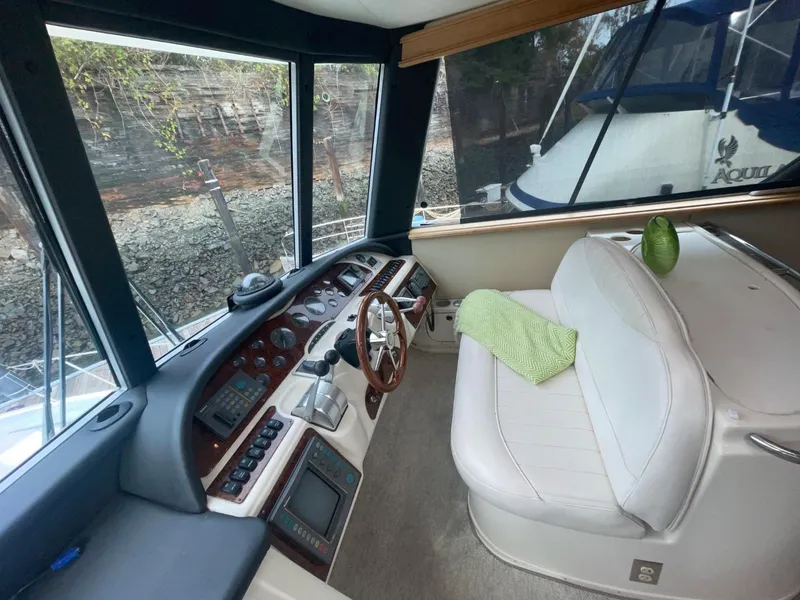 Slide: The Image of Interior of 1997 Maxum 4600 Custom SCB yacht with helm and seating area. - 21
