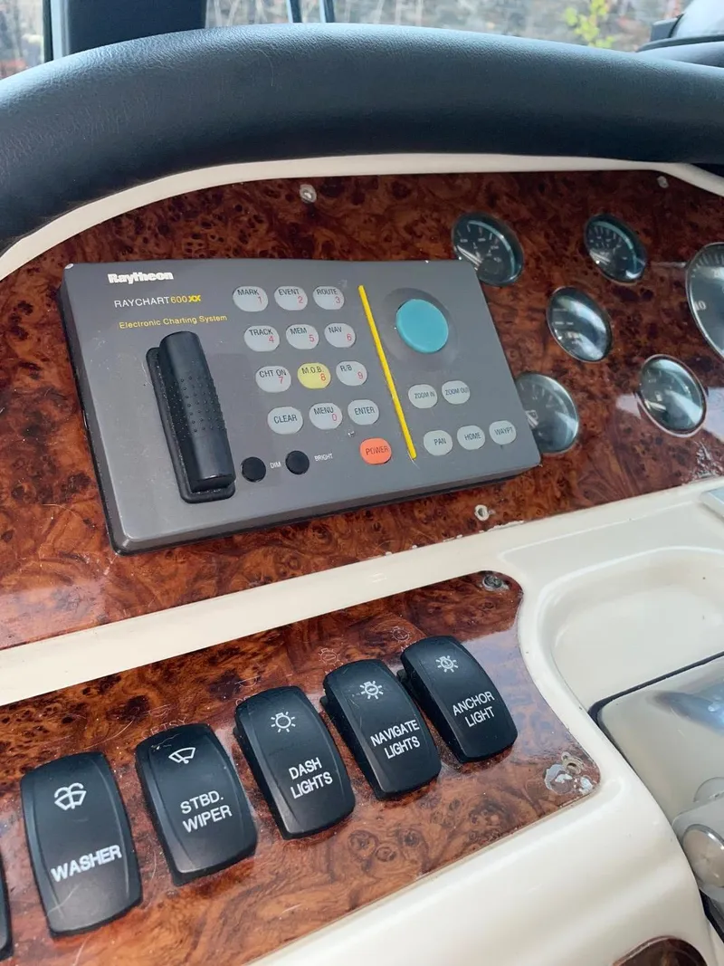 Slide: The Image of Control panel of a 1997 Maxum 4600 Custom SCB boat with navigation and light switches. - 24