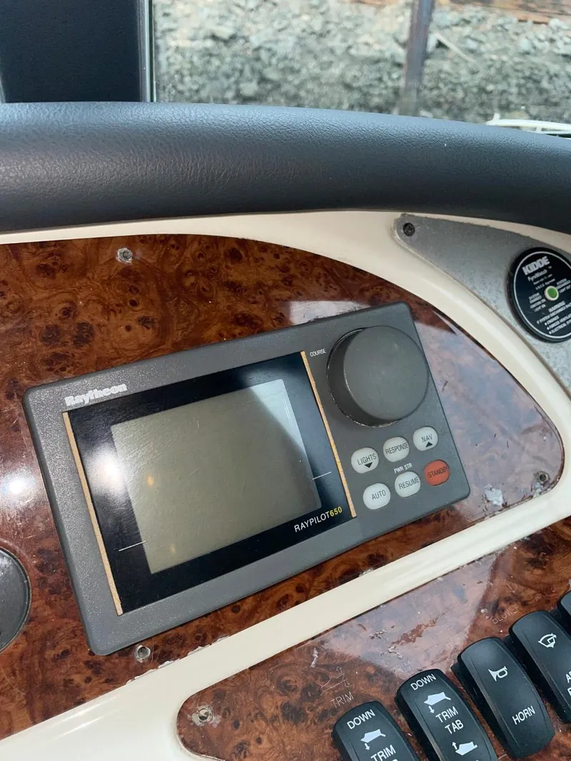Slide: The Image of Close-up of a 1997 Maxum 4600 Custom SCB boat's control panel with navigation display. - 27