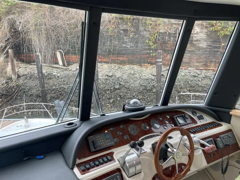 Slide: The Image of 1997 Maxum 4600 Custom SCB yacht helm with wood accents and navigational controls. - 30
