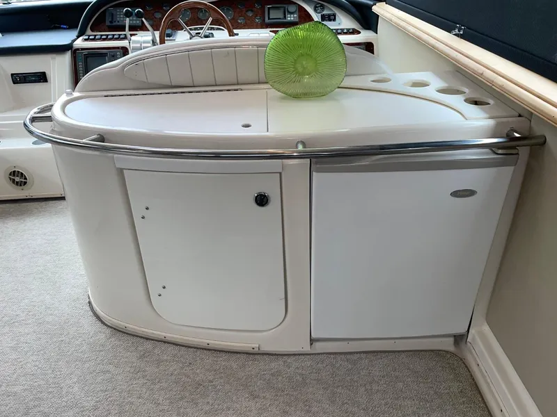 Slide: The Image of 1997 Maxum 4600 Custom SCB yacht interior with helm and green decorative plate. - 31