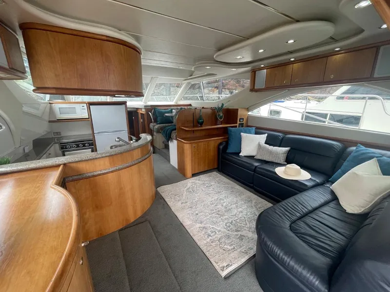 Slide: The Image of Luxurious interior of a 1997 Maxum 4600 Custom SCB yacht with leather seating and wood finishes. - 34
