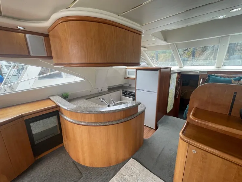 Slide: The Image of Luxurious 1997 Maxum 4600 Custom SCB yacht interior with modern kitchen and sleek wood finishes. - 41