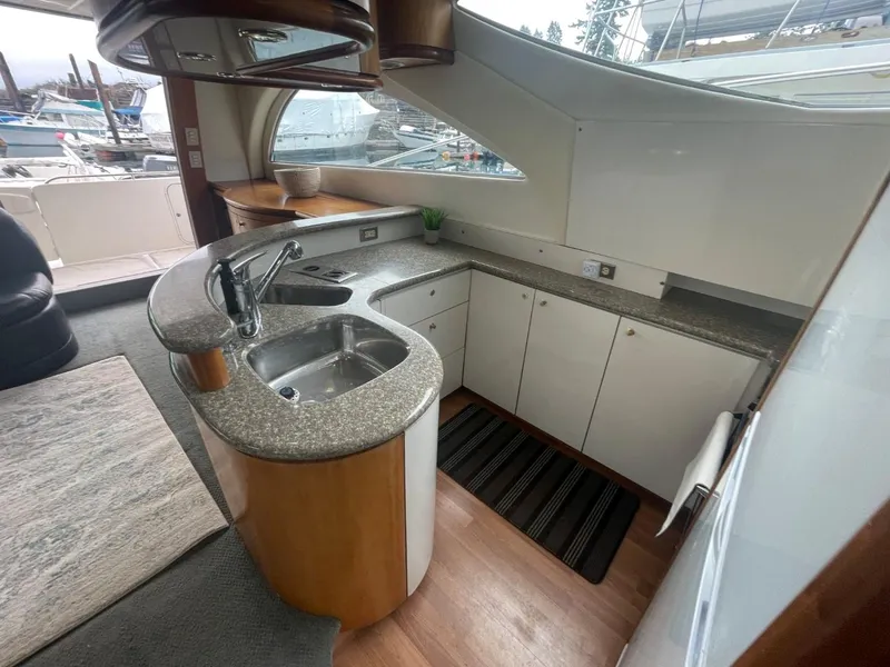 Slide: The Image of 1997 Maxum 4600 Custom SCB yacht kitchen with modern design and granite countertops. - 46