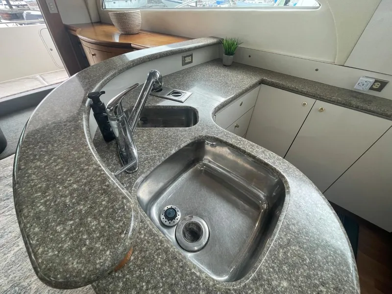 Slide: The Image of Luxurious kitchen area in a 1997 Maxum 4600 Custom SCB yacht with modern sink and countertop. - 48