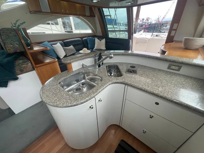 Slide: The Image of 1997 Maxum 4600 Custom SCB yacht interior with modern kitchen and cozy seating area. - 49