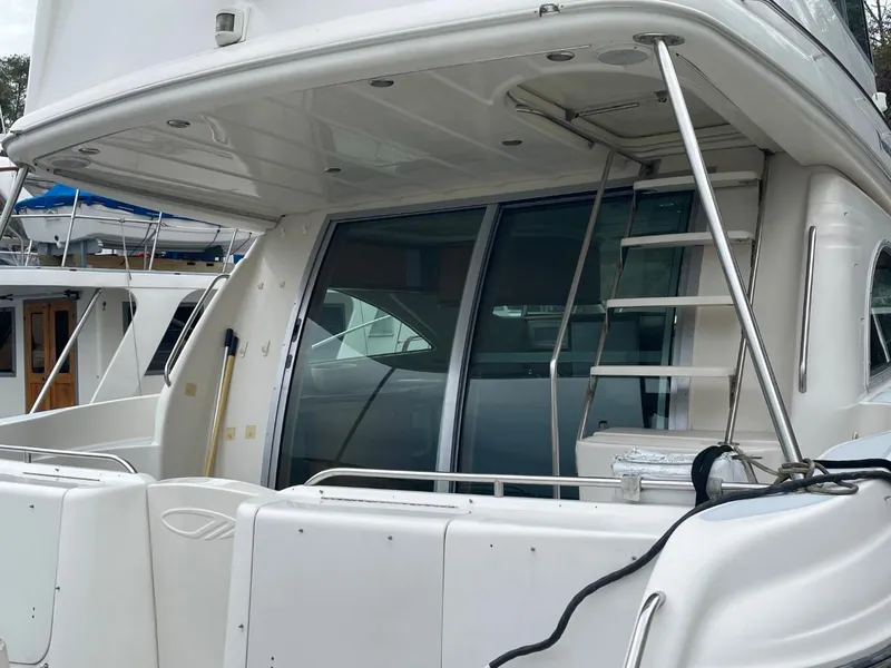 Slide: The Image of 1997 Maxum 4600 Custom SCB yacht with sleek design and ladder access. - 5