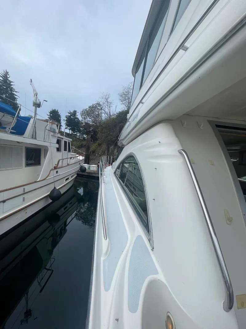 Slide: The Image of 1997 Maxum 4600 Custom SCB yacht docked beside other boats in a marina. - 7