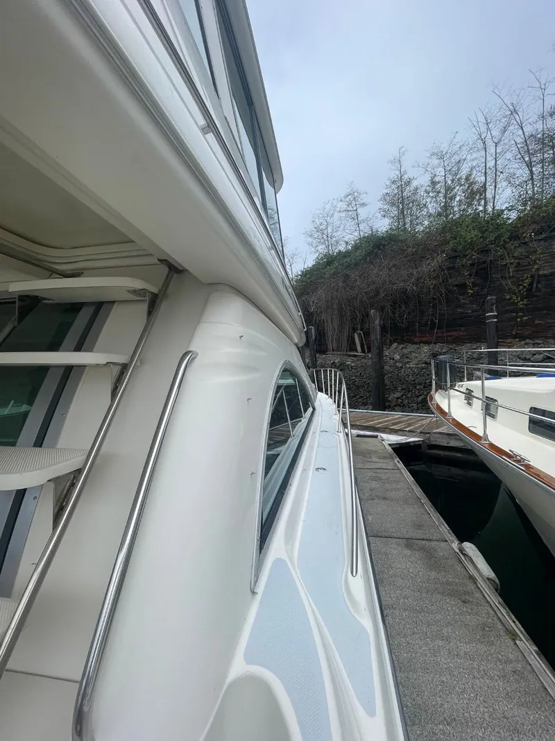 Slide: The Image of 1997 Maxum 4600 Custom SCB yacht docked beside a pier, showcasing sleek design. - 8