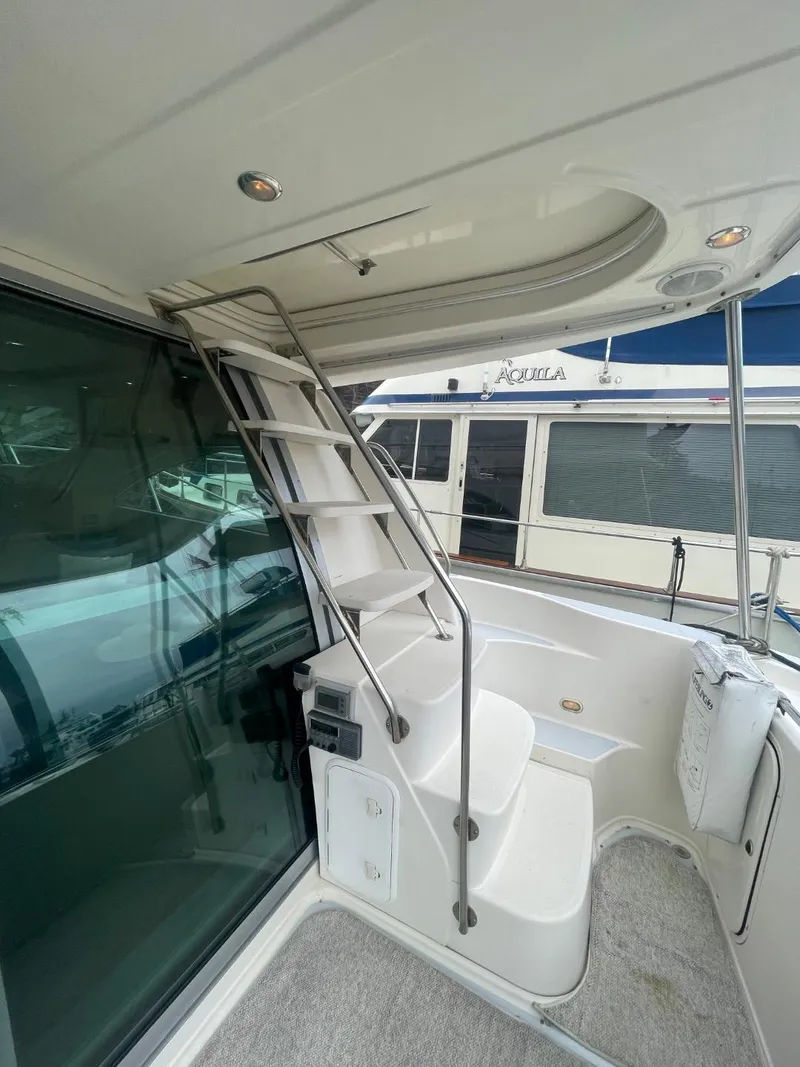 Slide: The Image of 1997 Maxum 4600 Custom SCB yacht with sleek interior staircase and modern design. - 9