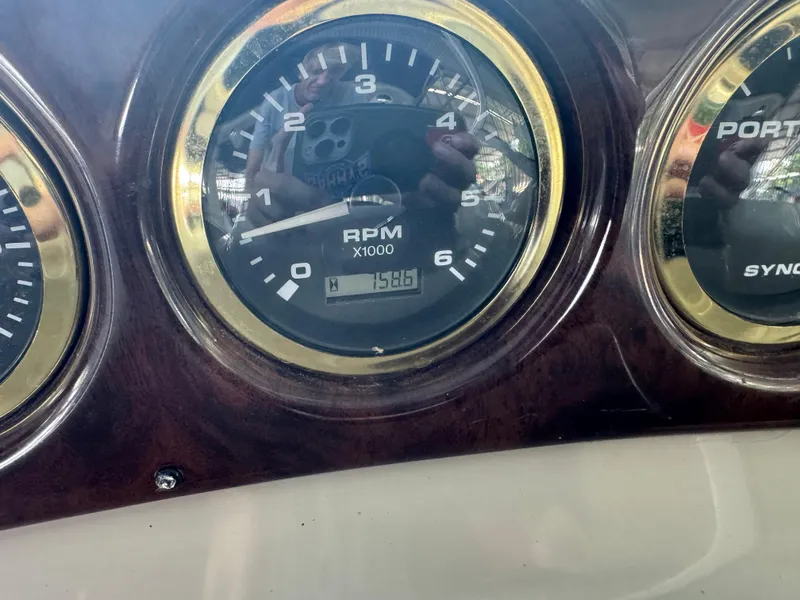 Slide: The Image of Close-up of Rinker 330 Fiesta Vee 2000 RPM gauge displaying 1586 hours. - 11