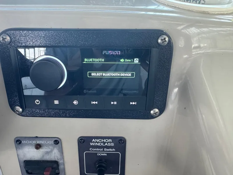 Slide: The Image of Fusion Bluetooth stereo and anchor windlass controls on 2000 Rinker 330 Fiesta Vee boat. - 13