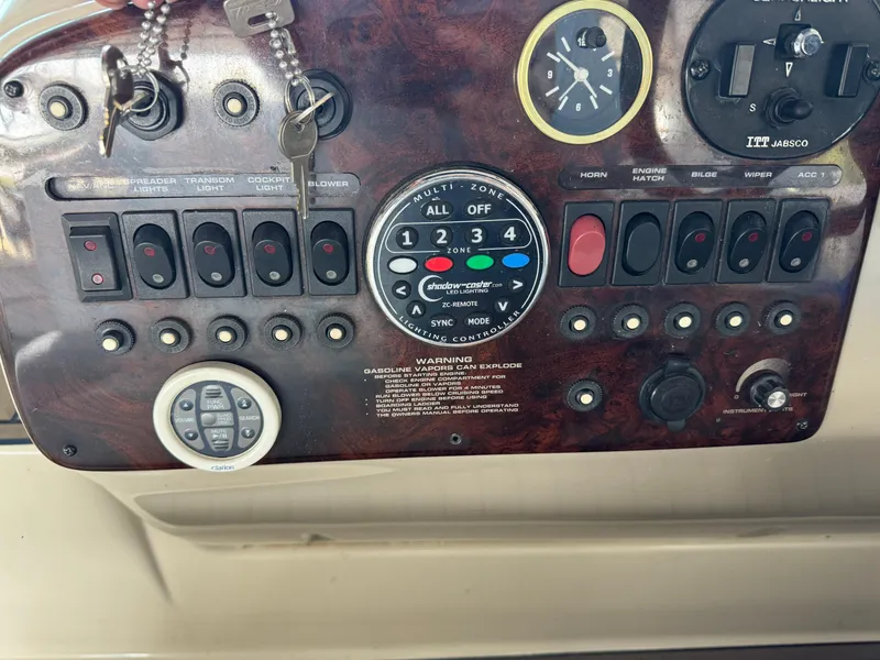 Slide: The Image of Control panel of 2000 Rinker 330 Fiesta Vee boat with switches and gauges. - 14