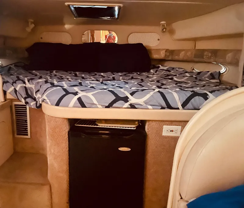 Slide: The Image of Interior cabin of 2000 Rinker 330 Fiesta Vee with bed and mini fridge. - 22